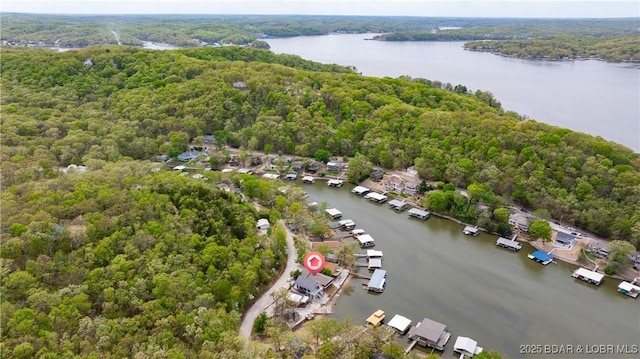 aerial view with a wooded view and a water view