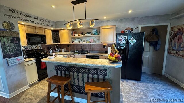 30993 Viewside Dr, Rocky Mount, MO 65072 - kitchen with light countertops, a center island, black appliances, backsplash, and baseboards