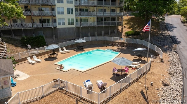 pool featuring a patio area and fence