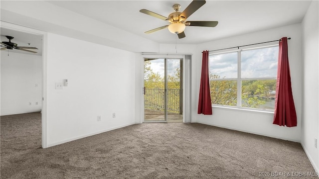 carpeted spare room with a healthy amount of sunlight and ceiling fan