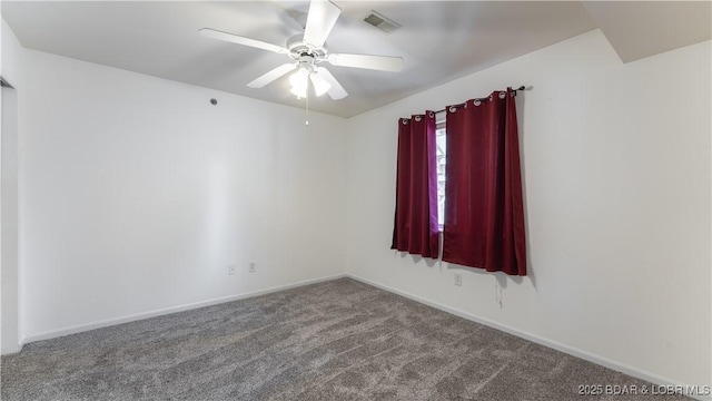 empty room with baseboards, visible vents, a ceiling fan, and carpet flooring