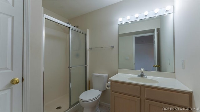 bathroom with toilet, a stall shower, and vanity