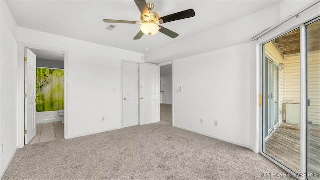 unfurnished bedroom featuring carpet, visible vents, ensuite bathroom, and baseboards