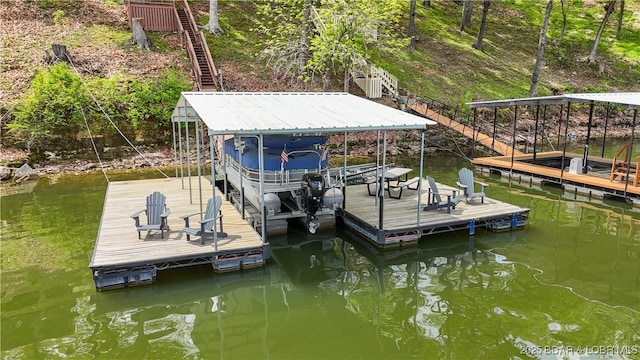 dock area featuring stairs, a water view, and boat lift