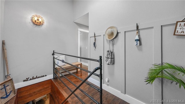 stairs featuring baseboards and wood finished floors