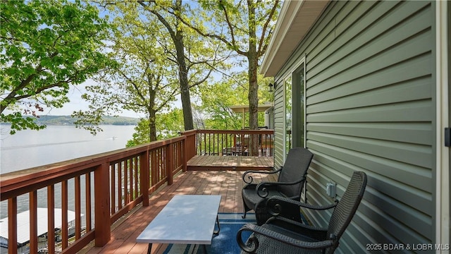 wooden terrace featuring a water view