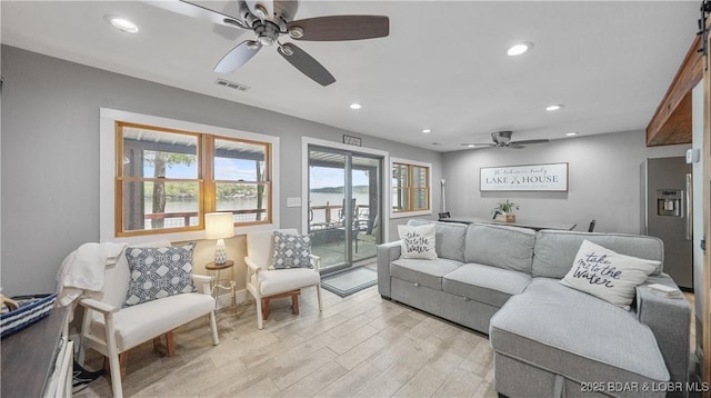 living room with recessed lighting, a ceiling fan, visible vents, and light wood-type flooring