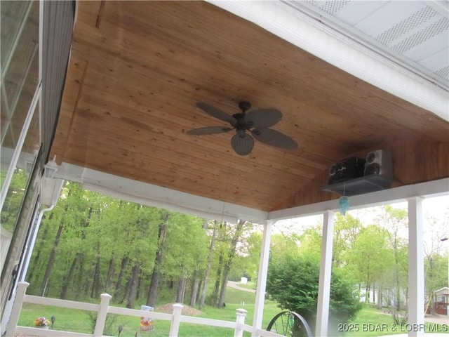 unfurnished sunroom with ceiling fan