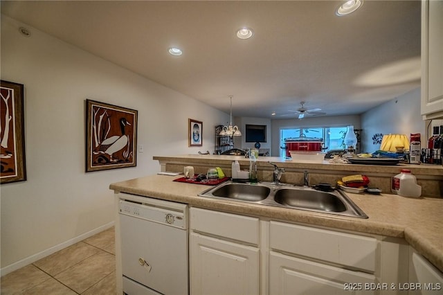 kitchen with a ceiling fan, light tile patterned flooring, white dishwasher, white cabinetry, and a sink