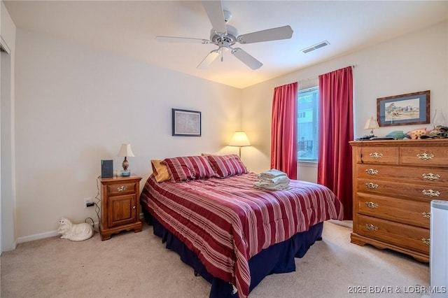 bedroom with a ceiling fan, baseboards, visible vents, and light carpet
