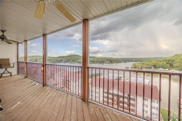 wooden terrace featuring a water view and ceiling fan