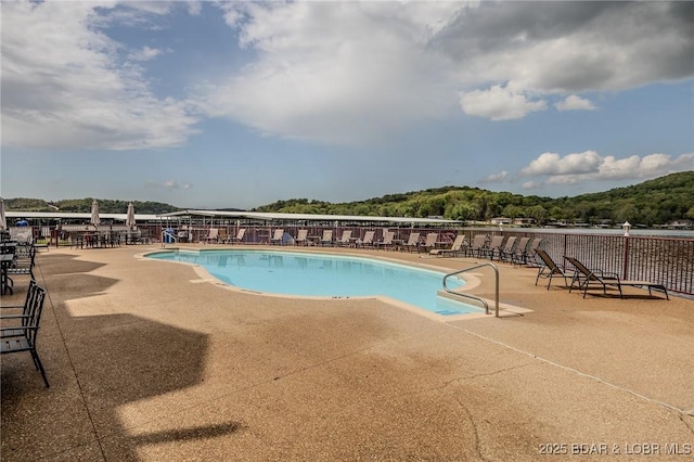 pool with fence and a patio area