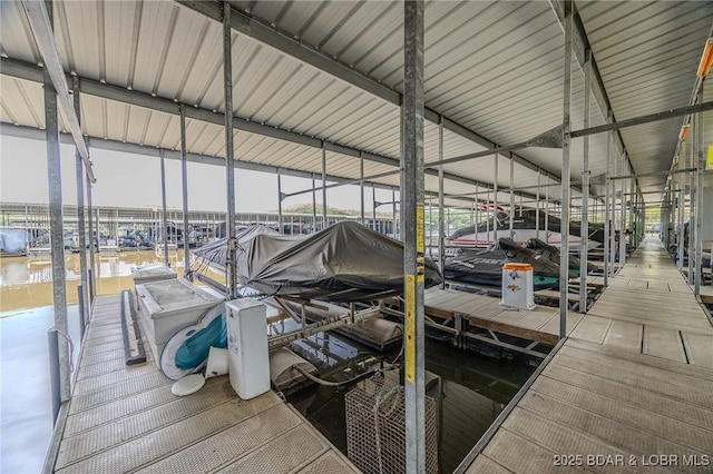 dock area with a water view and boat lift