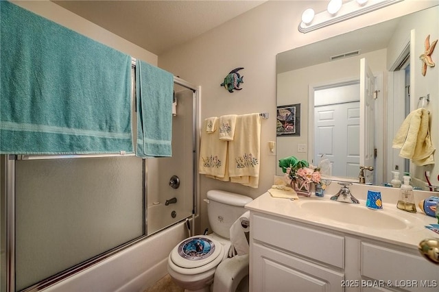 full bath featuring visible vents, bath / shower combo with glass door, toilet, and vanity
