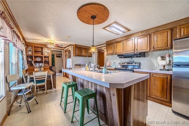 122 Simpson Rd, Urbana, MO 65767 - kitchen featuring brown cabinets, stainless steel appliances, a textured ceiling, and a sink