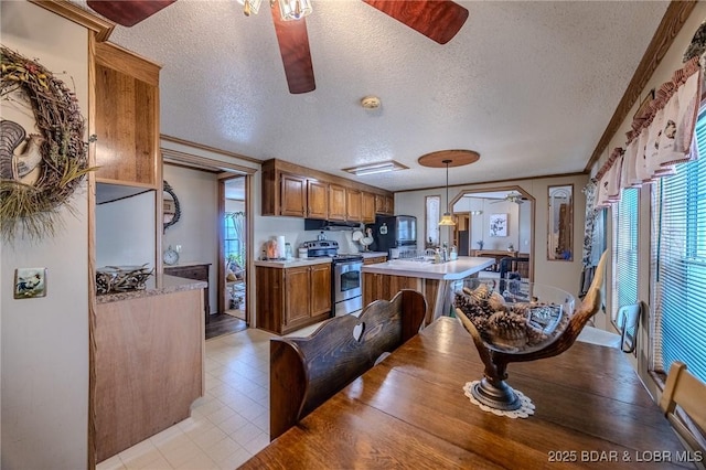 122 Simpson Rd, Urbana, MO 65767 - kitchen featuring brown cabinets, stainless steel range with electric cooktop, ceiling fan, and plenty of natural light