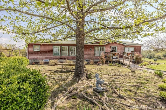 122 Simpson Rd, Urbana, MO 65767 - back of property with fence and faux log siding