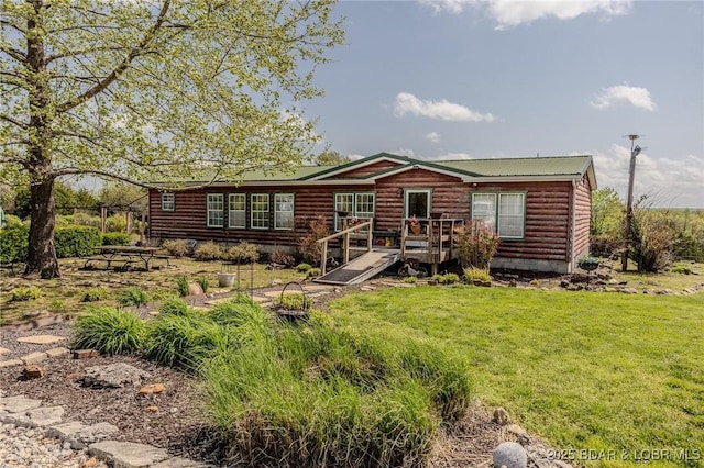 122 Simpson Rd, Urbana, MO 65767 - back of house featuring a yard, a deck, metal roof, and faux log siding
