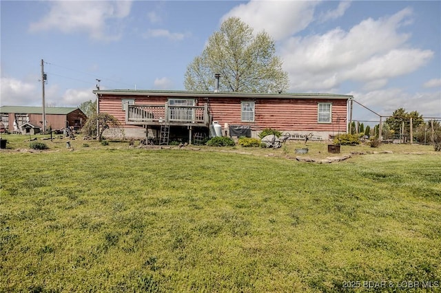 122 Simpson Rd, Urbana, MO 65767 - back of property featuring a lawn, fence, and a wooden deck