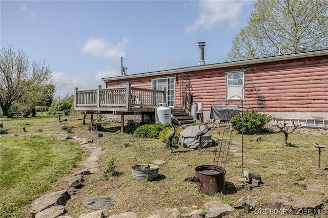 122 Simpson Rd, Urbana, MO 65767 - rear view of house featuring a wooden deck, log siding, and a yard