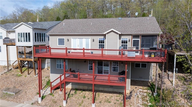back of property featuring a sunroom, a shingled roof, a wooden deck, and stairway
