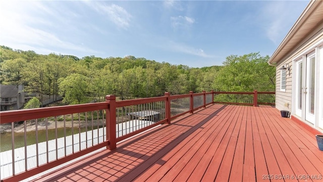 wooden terrace with a wooded view