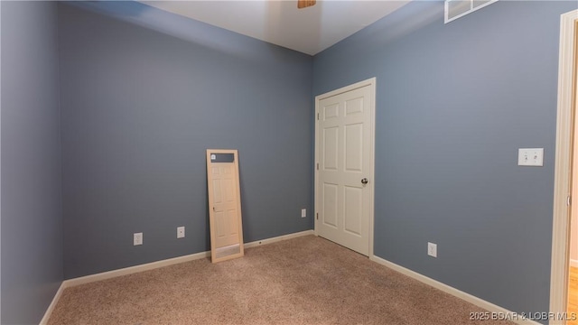 empty room with carpet floors and baseboards