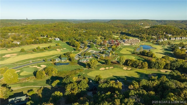 aerial view featuring a water view, a view of trees, and view of golf course