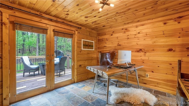 office area with wood ceiling, french doors, wood walls, and stone tile floors