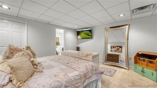 bedroom featuring baseboards, a drop ceiling, recessed lighting, and visible vents