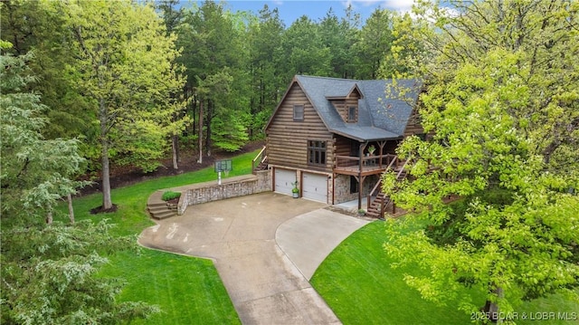 view of front of property featuring stone siding, log exterior, an attached garage, driveway, and stairway