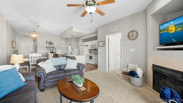 183 Upper Monarch Cove Ct Unit 4E, Lake Ozark, MO 65049 - living area with ceiling fan, light colored carpet, visible vents, a fireplace, and recessed lighting