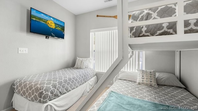 183 Upper Monarch Cove Ct Unit 4E, Lake Ozark, MO 65049 - bedroom with visible vents and lofted ceiling