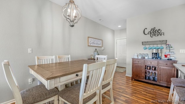 183 Upper Monarch Cove Ct Unit 4E, Lake Ozark, MO 65049 - dining room with an inviting chandelier and wood finished floors
