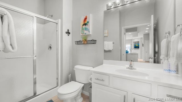 183 Upper Monarch Cove Ct Unit 4E, Lake Ozark, MO 65049 - bathroom featuring vanity, a shower stall, and toilet