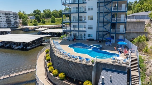 183 Upper Monarch Cove Ct Unit 4E, Lake Ozark, MO 65049 - view of swimming pool with fence, a floating dock, stairway, a water view, and a patio area