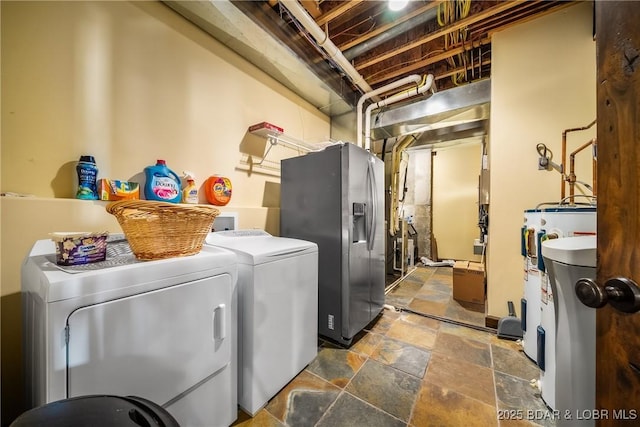 32 Wild Pines Ct, Sunrise Beach, MO 65079 - laundry area with independent washer and dryer, water heater, and stone finish flooring