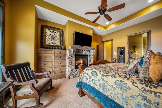 32 Wild Pines Ct, Sunrise Beach, MO 65079 - bedroom with carpet, a stone fireplace, recessed lighting, and ceiling fan