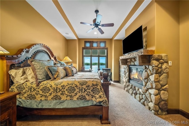 32 Wild Pines Ct, Sunrise Beach, MO 65079 - carpeted bedroom with a stone fireplace, a ceiling fan, and baseboards
