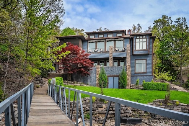 32 Wild Pines Ct, Sunrise Beach, MO 65079 - rear view of property with a balcony and a yard