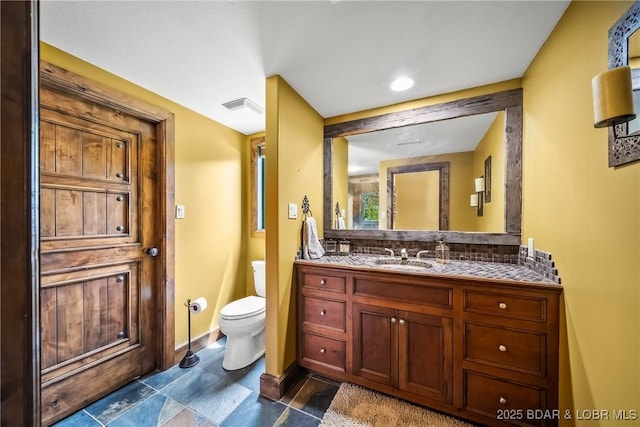 32 Wild Pines Ct, Sunrise Beach, MO 65079 - bathroom featuring toilet, decorative backsplash, baseboards, and vanity