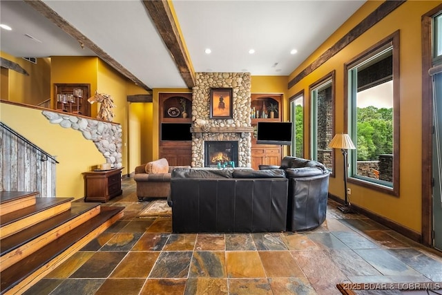 32 Wild Pines Ct, Sunrise Beach, MO 65079 - living room featuring stone tile floors, a stone fireplace, baseboards, beamed ceiling, and stairway