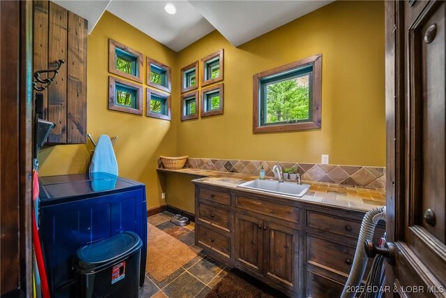 32 Wild Pines Ct, Sunrise Beach, MO 65079 - bathroom featuring vanity, tasteful backsplash, and baseboards