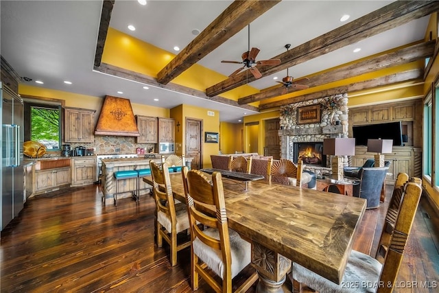 32 Wild Pines Ct, Sunrise Beach, MO 65079 - dining space featuring a fireplace, dark wood-style flooring, ceiling fan, recessed lighting, and beamed ceiling