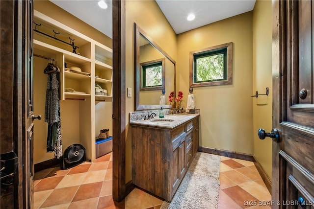 32 Wild Pines Ct, Sunrise Beach, MO 65079 - bathroom with vanity, baseboards, and tile patterned floors