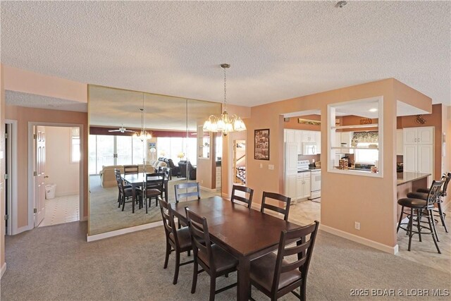 carpeted dining room with baseboards, a textured ceiling, and a chandelier