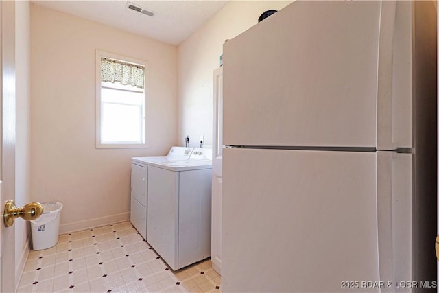 washroom featuring baseboards, laundry area, visible vents, and washer and clothes dryer