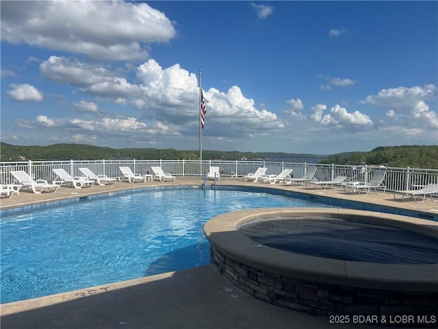 pool featuring fence and a patio