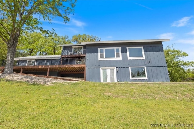 rear view of property with a lawn and a wooden deck