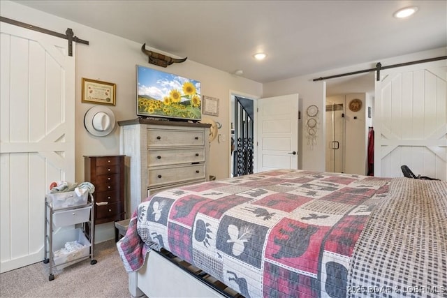 bedroom with carpet floors, recessed lighting, and a barn door